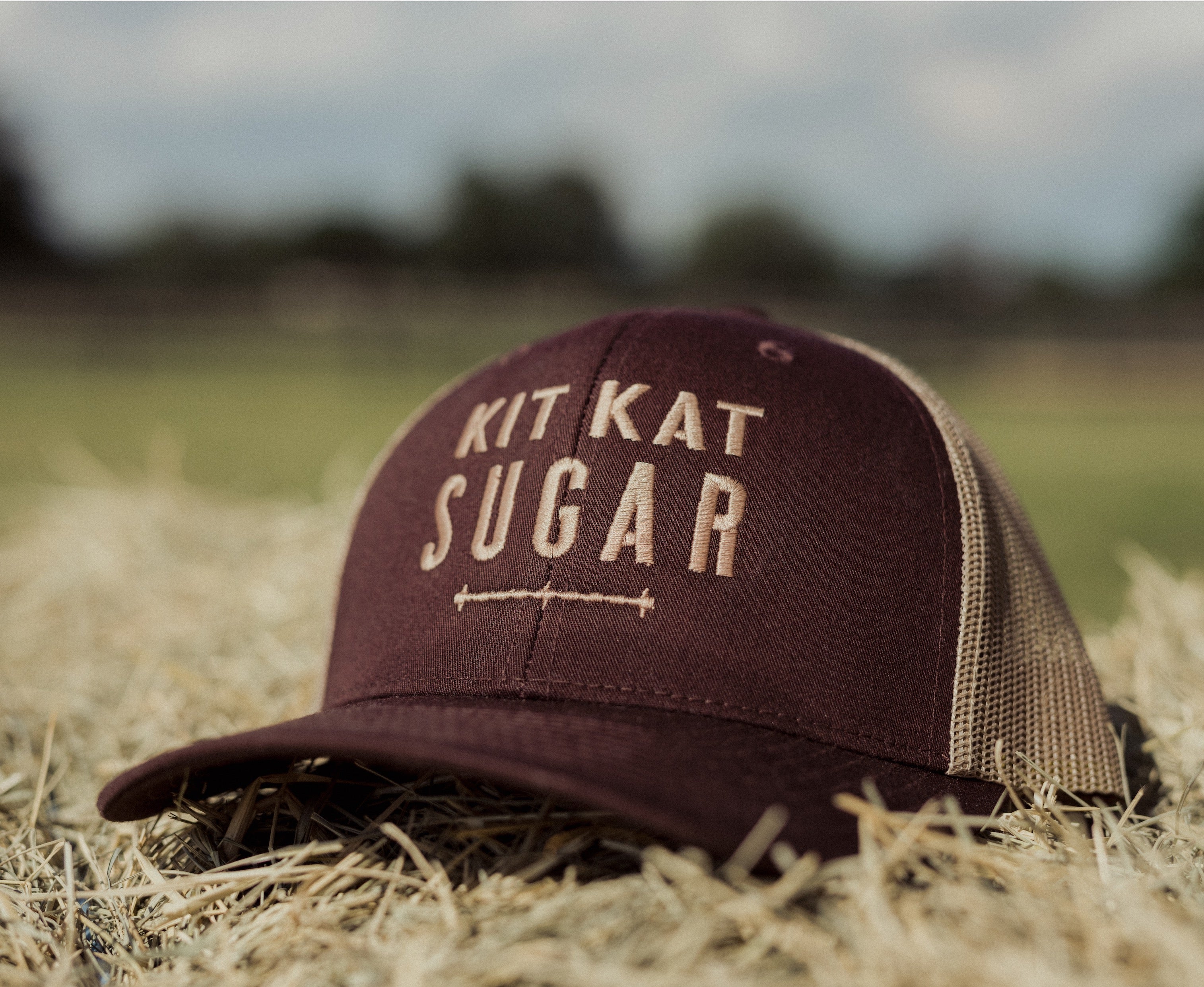 Brown Kit Kat Sugar ball cap sitting on a hay bale